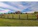 A large, grassy expanse enclosed by a rustic wooden fence, highlighting the property's open space at 2501 Remington Rd, Elizabeth, CO 80107