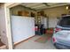 Organized garage with white cabinets, storage, and a silver SUV parked inside at 2501 Remington Rd, Elizabeth, CO 80107