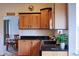 Light wood kitchen cabinets with dark granite countertops at 2501 Remington Rd, Elizabeth, CO 80107