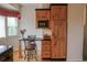 Eat-in kitchen with wood cabinets, black countertops, and a breakfast bar with seating at 2501 Remington Rd, Elizabeth, CO 80107