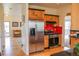 Bright kitchen featuring stainless steel appliances, wood cabinets with black trim, and access to the living room at 2501 Remington Rd, Elizabeth, CO 80107