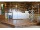 Rustic laundry room with wood accent wall, washer, dryer, and ample storage at 2501 Remington Rd, Elizabeth, CO 80107