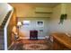 Comfortable living room with a warm rug, wood burning fireplace, and a staircase at 2501 Remington Rd, Elizabeth, CO 80107