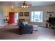 Comfortable living room with a bright red front door, bay window, and neutral carpet at 2501 Remington Rd, Elizabeth, CO 80107