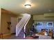 Cozy living room featuring a staircase, olive green walls, and rustic decor at 2501 Remington Rd, Elizabeth, CO 80107