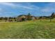 Expansive green lawn extending from the home's back, enclosed by a charming wooden fence at 2501 Remington Rd, Elizabeth, CO 80107