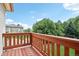 Balcony with wooden railings overlooking green trees and the neighborhood at 7760 Crestview Ln, Niwot, CO 80504