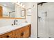 Bathroom featuring wood cabinets, white countertop, and glass enclosed shower at 7760 Crestview Ln, Niwot, CO 80504