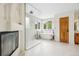 Bright bathroom featuring a modern walk-in shower, soaking tub, and stylish fireplace at 7760 Crestview Ln, Niwot, CO 80504