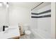Standard bathroom featuring a combined shower and bathtub with white tiled walls at 7760 Crestview Ln, Niwot, CO 80504