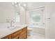 Bright bathroom features a tub/shower, and wood vanity with white countertop at 7760 Crestview Ln, Niwot, CO 80504