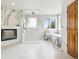 Bright bathroom featuring a modern walk-in shower, soaking tub, and stylish fireplace at 7760 Crestview Ln, Niwot, CO 80504