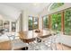 Bright dining room with large window view, showing table with white modern chairs and a tile floor at 7760 Crestview Ln, Niwot, CO 80504