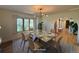 This staged dining room features a modern table and chairs, bright window and an archway into the home at 7760 Crestview Ln, Niwot, CO 80504