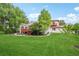 Lush backyard of a charming home with a beautiful lawn and mature trees at 7760 Crestview Ln, Niwot, CO 80504