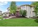 Charming two-story home with a tile roof, a landscaped yard, and mature trees at 7760 Crestview Ln, Niwot, CO 80504