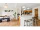 Bright kitchen with a breakfast bar, modern light fixtures, and tile floors at 7760 Crestview Ln, Niwot, CO 80504