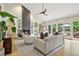 Sunlit living room with a stone fireplace, built-in bookshelves, and plush seating at 7760 Crestview Ln, Niwot, CO 80504