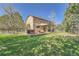 Expansive backyard featuring a patio with outdoor seating and a hot tub, perfect for relaxation and entertainment at 18971 E Pinewood Dr, Aurora, CO 80016