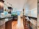 Finished basement with a kitchen, bar seating and wood plank flooring at 18971 E Pinewood Dr, Aurora, CO 80016