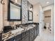 Updated bathroom with granite counters, dual sinks, and decorative stone backsplash at 18971 E Pinewood Dr, Aurora, CO 80016