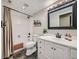 Bathroom featuring a shower-tub, a white vanity, and dark slate flooring at 18971 E Pinewood Dr, Aurora, CO 80016