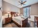 A cozy bedroom features neutral colored walls, patterned drapes, and a ceiling fan at 18971 E Pinewood Dr, Aurora, CO 80016