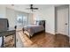 Bright bedroom with hardwood floors, a ceiling fan, and natural light at 18971 E Pinewood Dr, Aurora, CO 80016