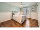 Inviting bedroom featuring hardwood floors, natural light, and white wainscoting at 18971 E Pinewood Dr, Aurora, CO 80016