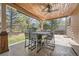 Inviting covered patio featuring wood ceiling, fan, outdoor dining set and a view of the backyard at 18971 E Pinewood Dr, Aurora, CO 80016