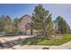 Corner lot featuring a two-story home with a three-car garage, landscaping, and mature trees at 18971 E Pinewood Dr, Aurora, CO 80016