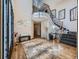 Grand foyer featuring a curved staircase, chandelier, and decorative tiled entryway at 18971 E Pinewood Dr, Aurora, CO 80016