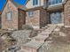 Elegant front entrance featuring stone steps and a decorative, wrought-iron door at 18971 E Pinewood Dr, Aurora, CO 80016