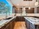 A spacious kitchen with granite countertops, modern appliances, and a large window for plenty of natural light at 18971 E Pinewood Dr, Aurora, CO 80016