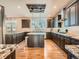 Spacious kitchen with wooden cabinets, granite countertops and an island with room for seating at 18971 E Pinewood Dr, Aurora, CO 80016