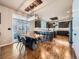 A kitchen with stainless steel appliances, granite countertops, dark cabinets, and adjacent dining area at 18971 E Pinewood Dr, Aurora, CO 80016