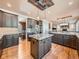 A kitchen with stainless steel appliances, granite countertops, and dark cabinets with hardwood floors at 18971 E Pinewood Dr, Aurora, CO 80016