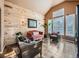 Comfortable living room featuring wood-paneled wall, modern furnishings, and natural light at 18971 E Pinewood Dr, Aurora, CO 80016