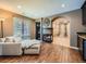A cozy living room featuring a fireplace, a large sofa, and hardwood floors. Perfect for relaxation! at 18971 E Pinewood Dr, Aurora, CO 80016