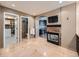 An open concept living space with travertine tile, a fireplace, and access to a bathroom and kitchen at 18971 E Pinewood Dr, Aurora, CO 80016