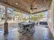 Covered patio featuring an outdoor dining set and a hot tub in the background at 18971 E Pinewood Dr, Aurora, CO 80016