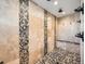 Luxurious walk-in shower featuring natural stone accents, rainfall showerhead, and convenient bench seating at 18971 E Pinewood Dr, Aurora, CO 80016