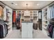 A spacious walk-in closet featuring custom shelving and an island at 18971 E Pinewood Dr, Aurora, CO 80016