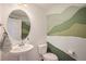 Powder room with pedestal sink and mountain mural at 7880 Horsebrush Ln # A, Littleton, CO 80125