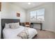 Cozy bedroom with a desk, chair, and large window at 7880 Horsebrush Ln # A, Littleton, CO 80125