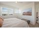 Spacious primary bedroom with large bed and mountain artwork at 7880 Horsebrush Ln # A, Littleton, CO 80125