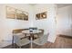 Cozy dining nook with wood bench and round glass table at 7880 Horsebrush Ln # A, Littleton, CO 80125