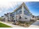 Modern two-story townhome with gray siding and stone accents at 7880 Horsebrush Ln # A, Littleton, CO 80125