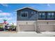 Two car attached garage with neutral color scheme at 7880 Horsebrush Ln # A, Littleton, CO 80125