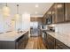 Modern kitchen with granite countertops, stainless steel appliances, and an island at 7880 Horsebrush Ln # A, Littleton, CO 80125